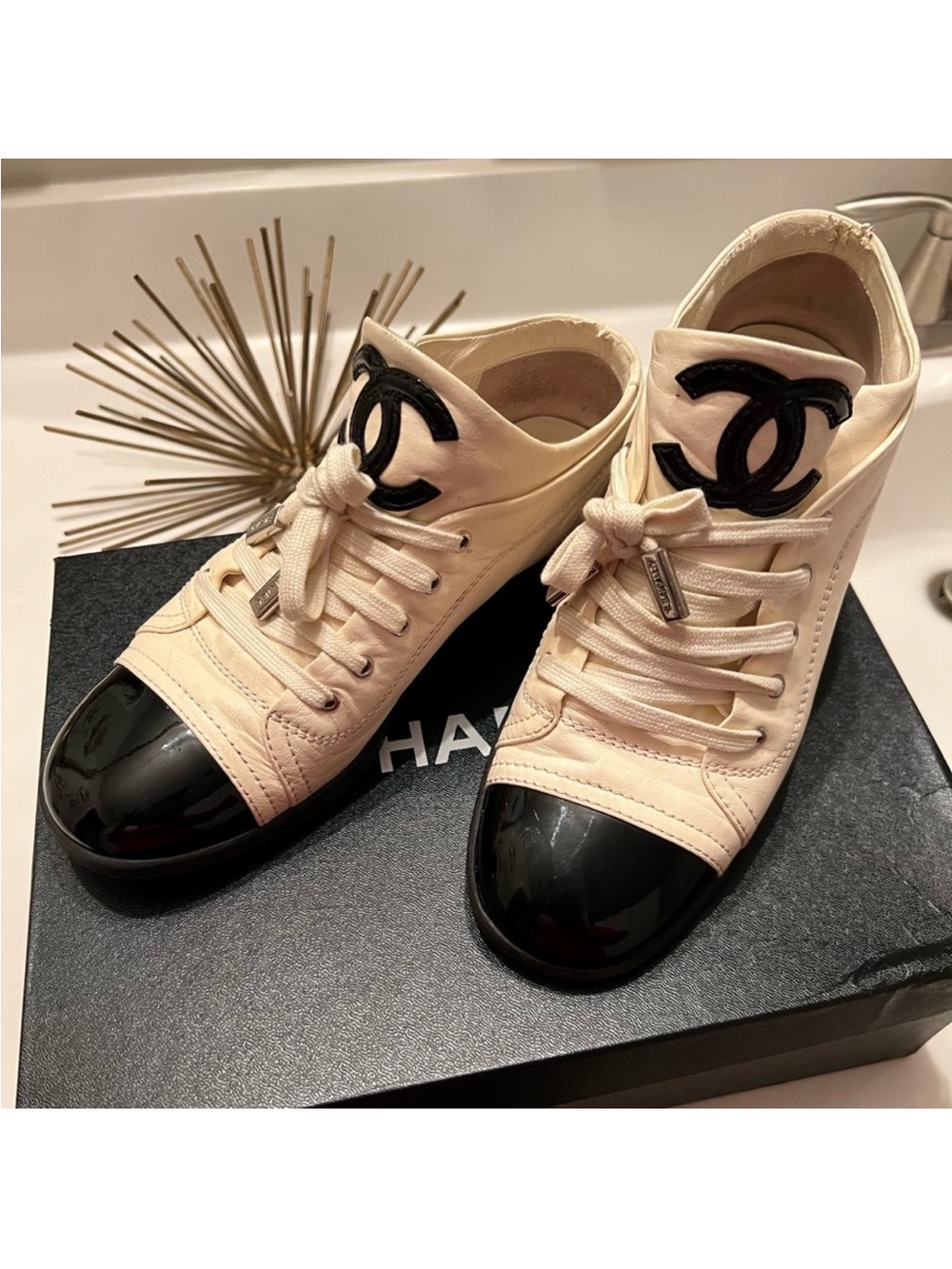 CHANEL Cream Canvas Low-Top Sneakers with Black Patent Cap Toe